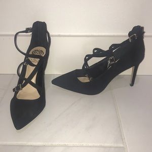 Black high heels with straps across top of foot